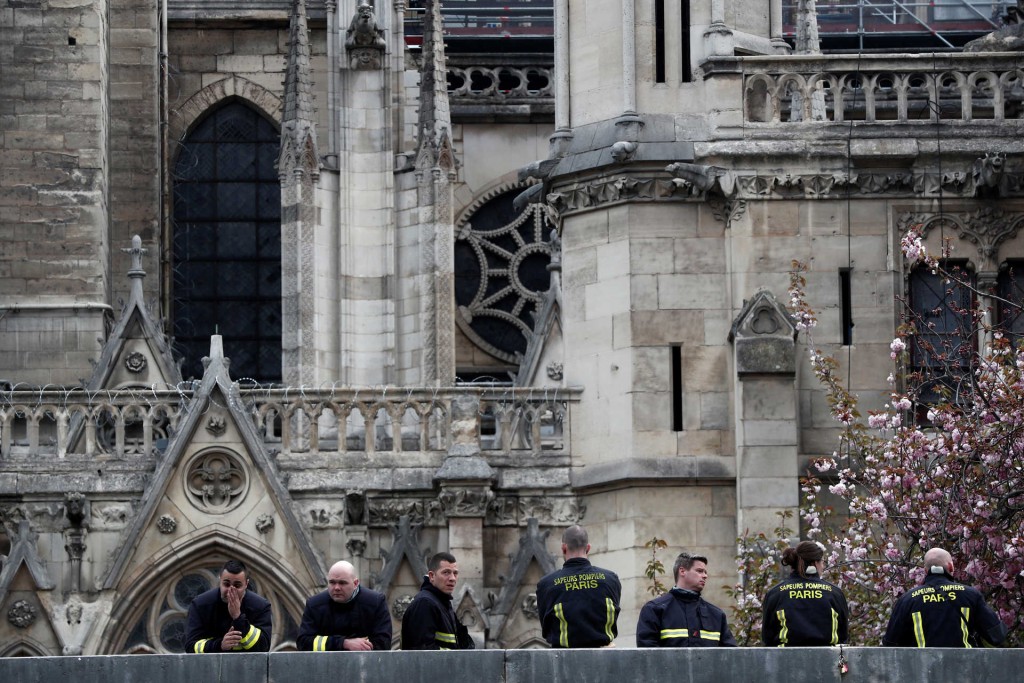 Firefighters work at Notre-Dame Cathedral after a massive fire devastated large parts of the gothic gem in Paris, France, April 16, 2019. REUTERS/Benoit Tessier