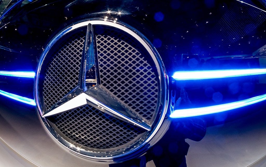 The logo of Mercedes Benz is pictured at the booth of the Daimler AG on the grounds of the IAA Nutzfahrzeuge (IAA Commercial Vehicles) fair on September 21, 2016 in Hanover, northern Germany. - The IAA Commercial Vehicles trade show for transport, logistics and mobility, will open its doors for visitors from September 22 to 29, 2016. According to the organisers, 2013 exhibitors from 52 countries will present their trends as digitization, electric mobility and urban logistics. (Photo by Peter Steffen / dpa / AFP) / Germany OUT