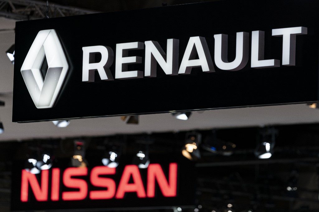 Renault and Nissan automobile logos are pictured during the Brussels Motor Show on January 9, 2020 in Brussels. (Photo by Kenzo TRIBOUILLARD / AFP)