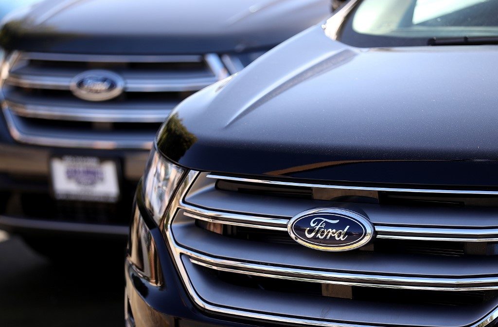 COLMA, CA - MARCH 29: The Ford logo is displayed on a new Ford car on the sales lot at a Ford dealership on March 29, 2017 in Colma, California. Ford announced that it is recalling more than 441,000 vehicles in North America at the cost of $295 million to fix problems that might cause engine fires and doors latches to unexpectedly malfunction. Justin Sullivan/Getty Images/AFP